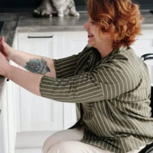 Lady in a wheelchair cooking in a kitchen.